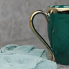 Grüne Keramiktasse mit Goldrand